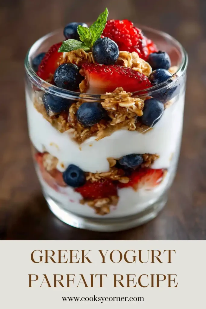 Berry Greek Yogurt Parfait with layers of yogurt, granola, and fresh fruit arranged in a mason jar. The parfait is topped with honey and colorful berries.