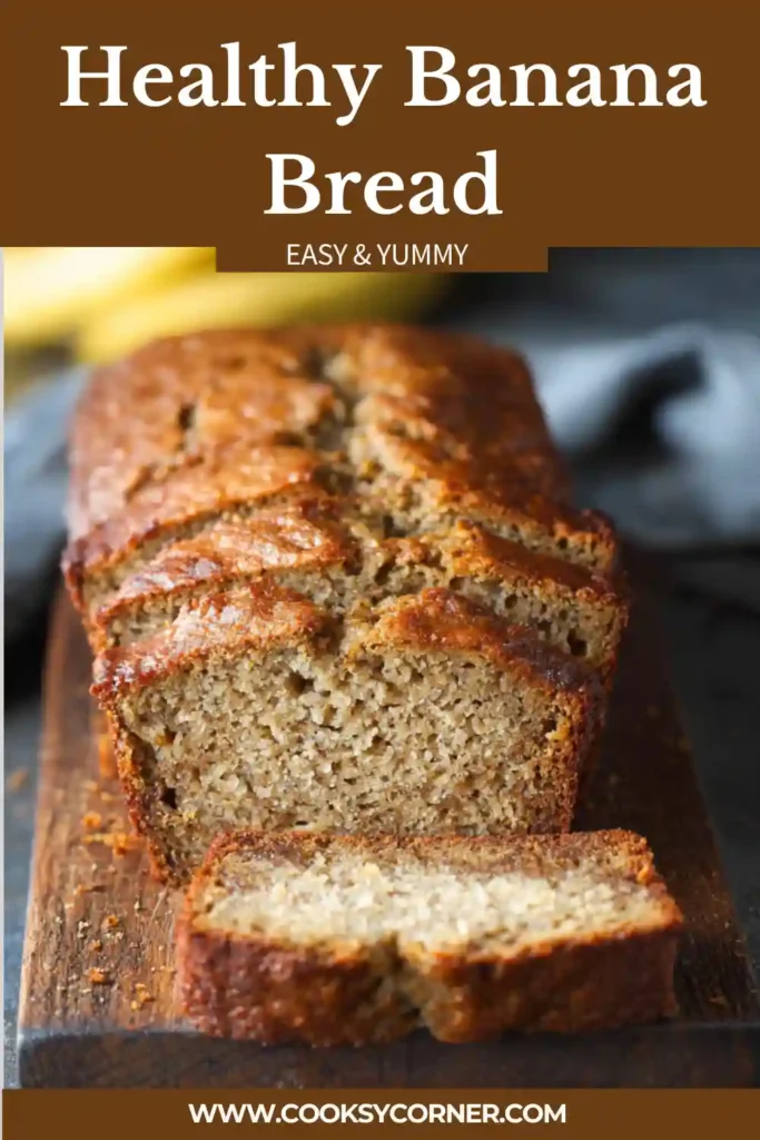 Freshly baked Healthy Banana Bread sliced on a wooden board with visible banana texture and a golden brown crust. This moist homemade banana bread is perfect for breakfast or snacking.