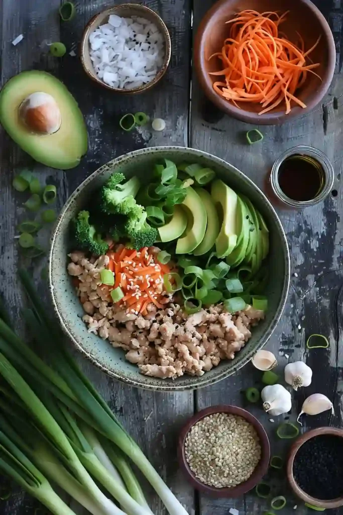 Healthy low-carb Egg Roll In A Bowl with sesame ginger sauce and fresh vegetables served warm in a bowl. This easy Asian-inspired dinner is gluten-free and family-friendly.