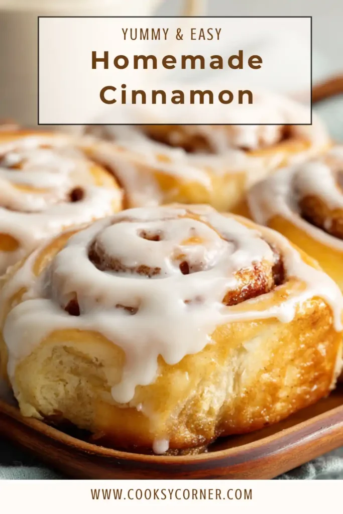Freshly baked Homemade Cinnamon Rolls covered with creamy cream cheese glaze in a baking dish. The soft cinnamon buns have golden edges and gooey cinnamon swirls.