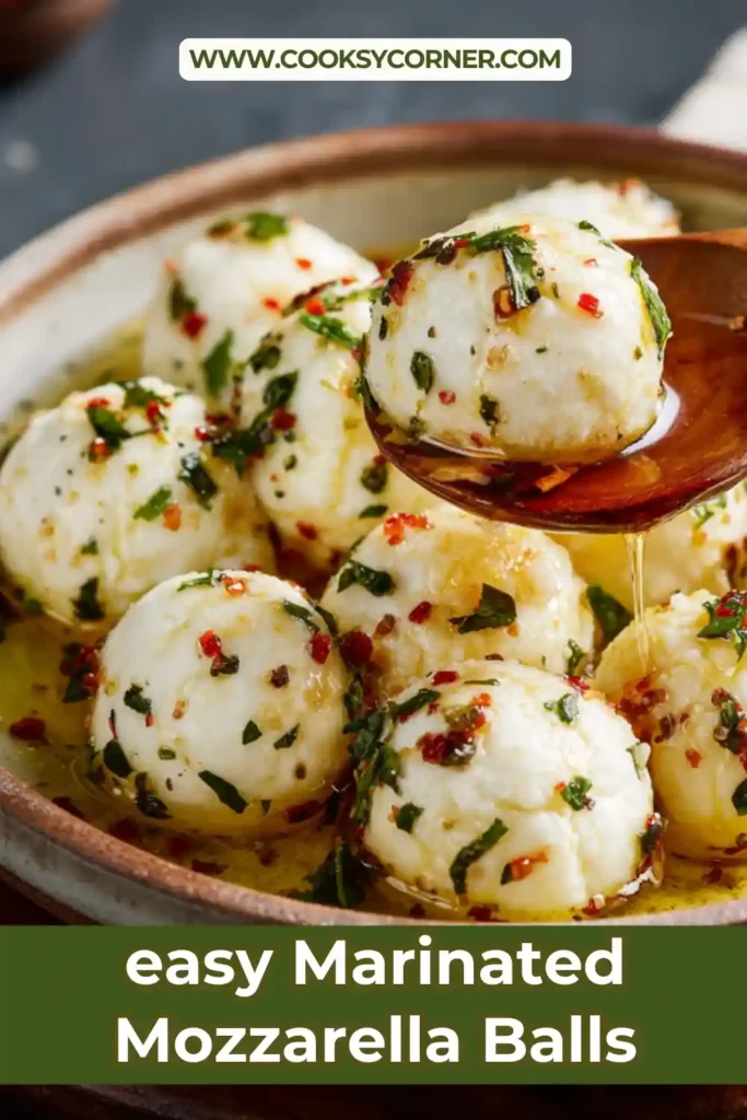 A jar of Marinated Mozzarella Balls mixed with fresh parsley, basil, garlic, lemon zest, and olive oil. This easy Italian appetizer looks fresh, creamy, and flavorful.