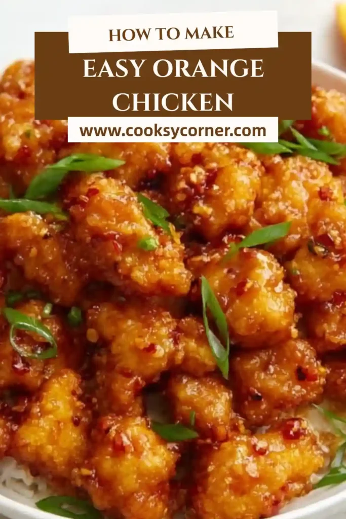 A bowl of crispy orange chicken served over steamed rice with green onions and fresh orange zest. The glossy citrus sauce coats every piece perfectly.