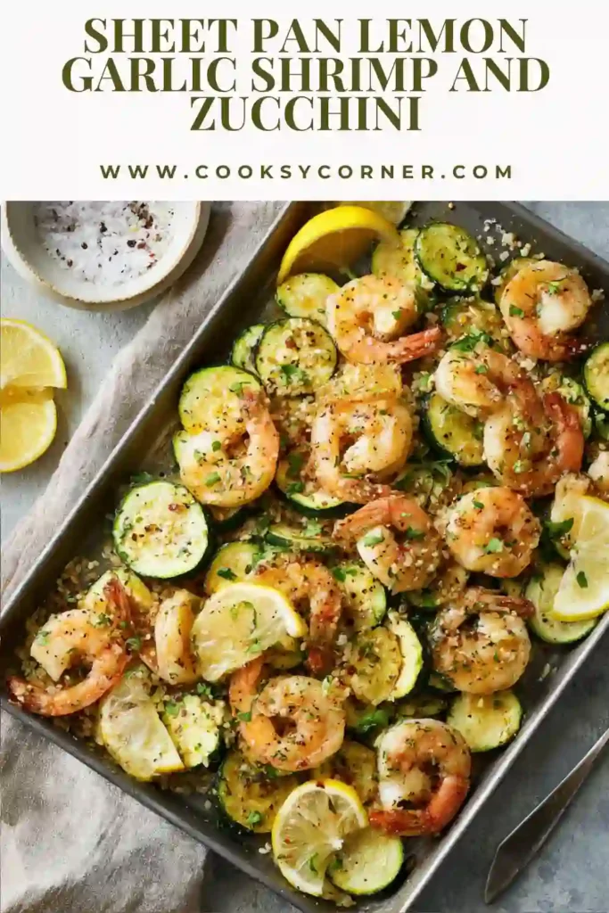 Sheet Pan Lemon Garlic Shrimp and Zucchini roasted with onions, fresh lemon, and parsley on a baking sheet.