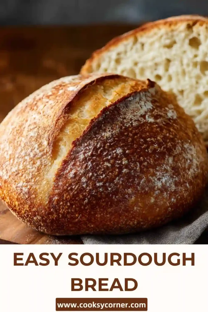 Rustic homemade sourdough bread sliced on a wooden cutting board showing an airy interior and crunchy crust. Easy sourdough bread recipe made with active starter.