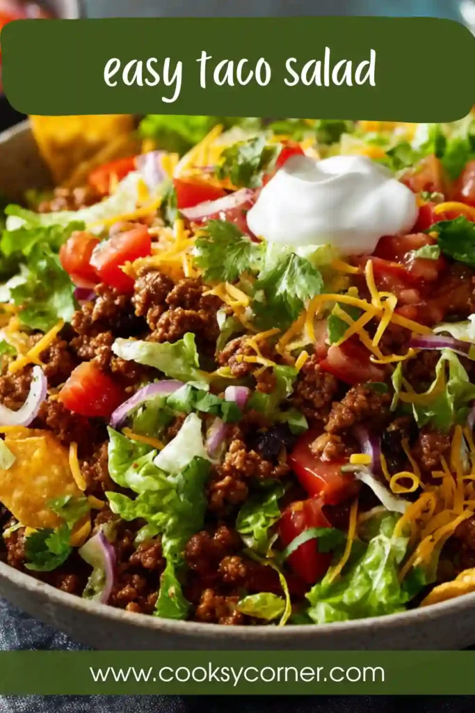 Ground beef taco salad served with black beans, fresh cilantro, crispy tortilla strips, and creamy sour cream in a vibrant homemade presentation.