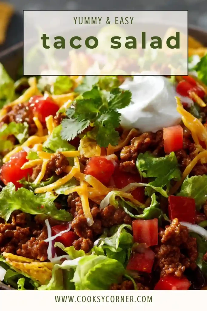 A fresh Taco Salad Recipe topped with seasoned ground beef, shredded cheddar cheese, black beans, cherry tomatoes, and crispy tortilla strips in a large serving bowl.
