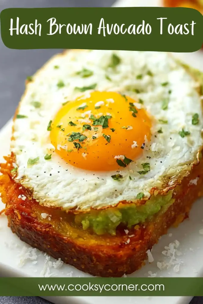 Crispy Hash Brown Avocado Toast topped with creamy mashed avocado, fresh parsley, and red pepper flakes on a serving plate. This savory breakfast recipe features golden shredded potatoes and fresh avocado.