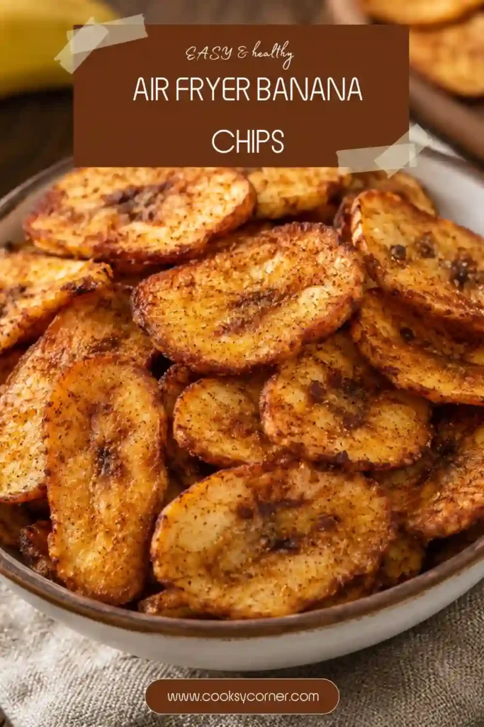 Golden crispy banana chips with cinnamon displayed on a wooden serving board beside fresh bananas.