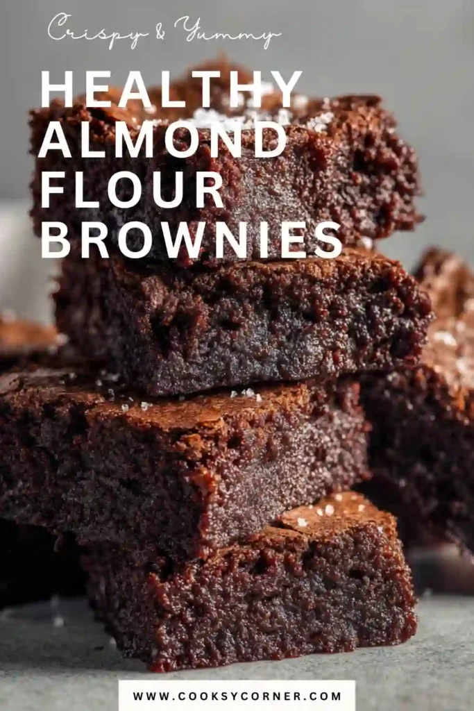 Chocolate almond flour brownies stacked on a dessert plate with visible chocolate chips. Perfect for a healthy sweet treat.