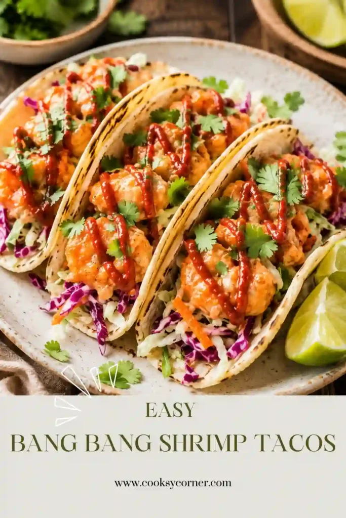 A plate of easy bang bang shrimp tacos filled with crispy golden shrimp and colorful cabbage slaw. Fresh cilantro and green onions add vibrant flavor and texture to this healthy taco recipe.