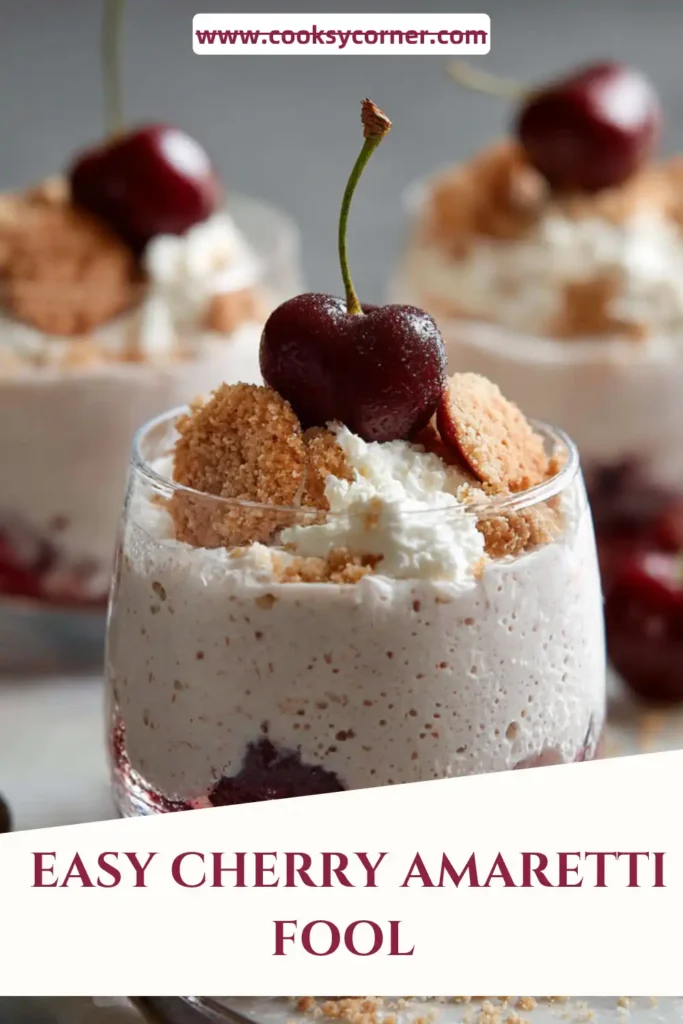 A glass of Bing Cherry Amaretti Fool topped with whipped cream, fresh cherries, and crushed amaretti cookies. This creamy cherry dessert showcases vibrant summer fruit and almond flavors.
