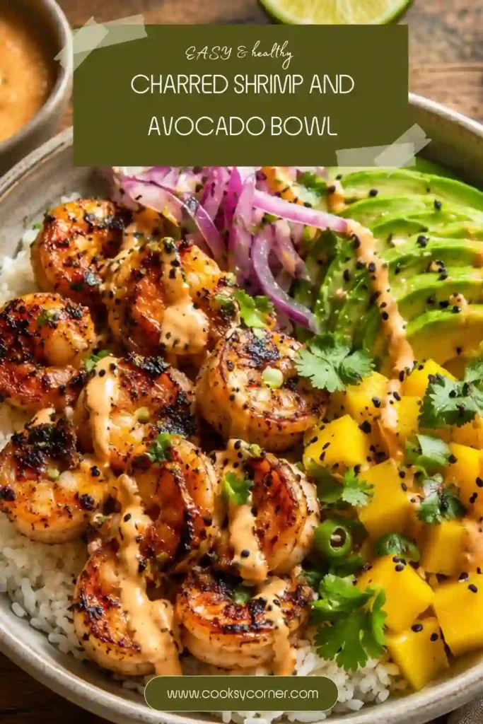 A colorful Charred Shrimp and Avocado Bowl topped with smoky shrimp, sliced avocado, mango salsa, and black sesame seeds over fluffy rice. The bowl is fresh, vibrant, and packed with bold flavors.