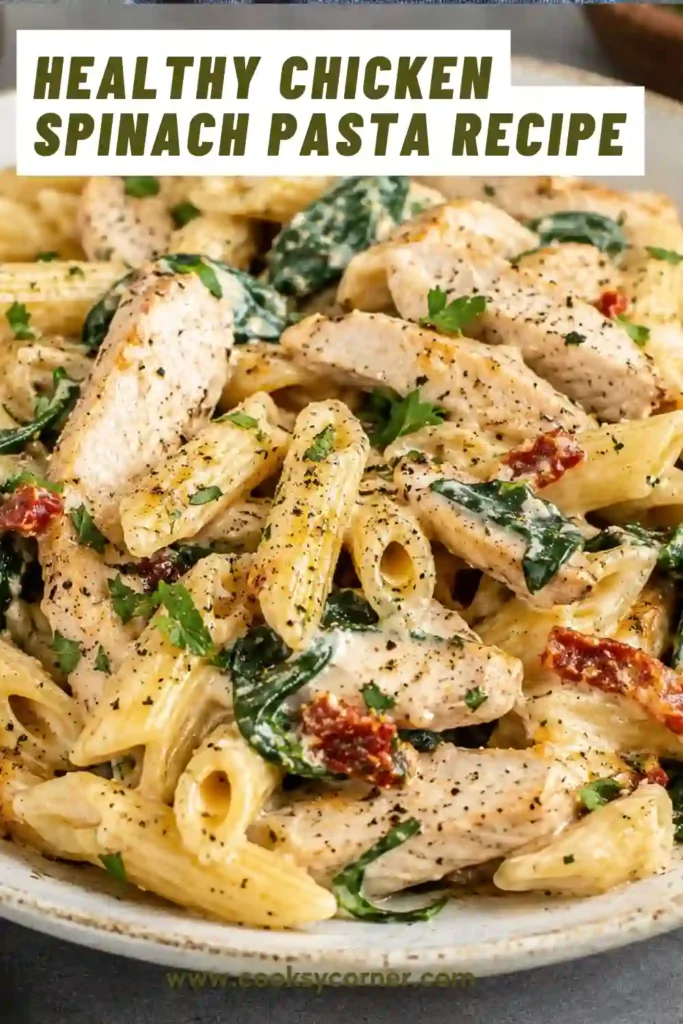 Creamy chicken pasta featuring spinach, garlic, and Parmesan cheese. This comforting weeknight meal is garnished with parsley and freshly ground black pepper.