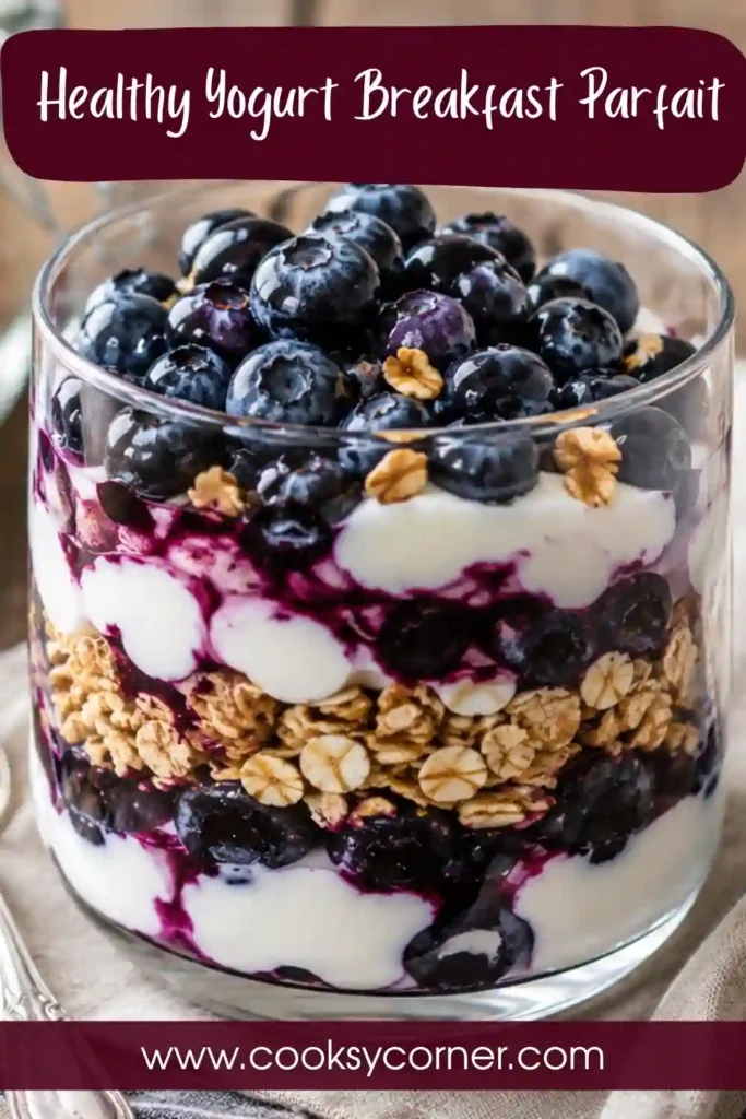 Greek yogurt parfait topped with blueberries and crunchy cereal. This easy breakfast parfait offers a delicious combination of creamy and crunchy textures.