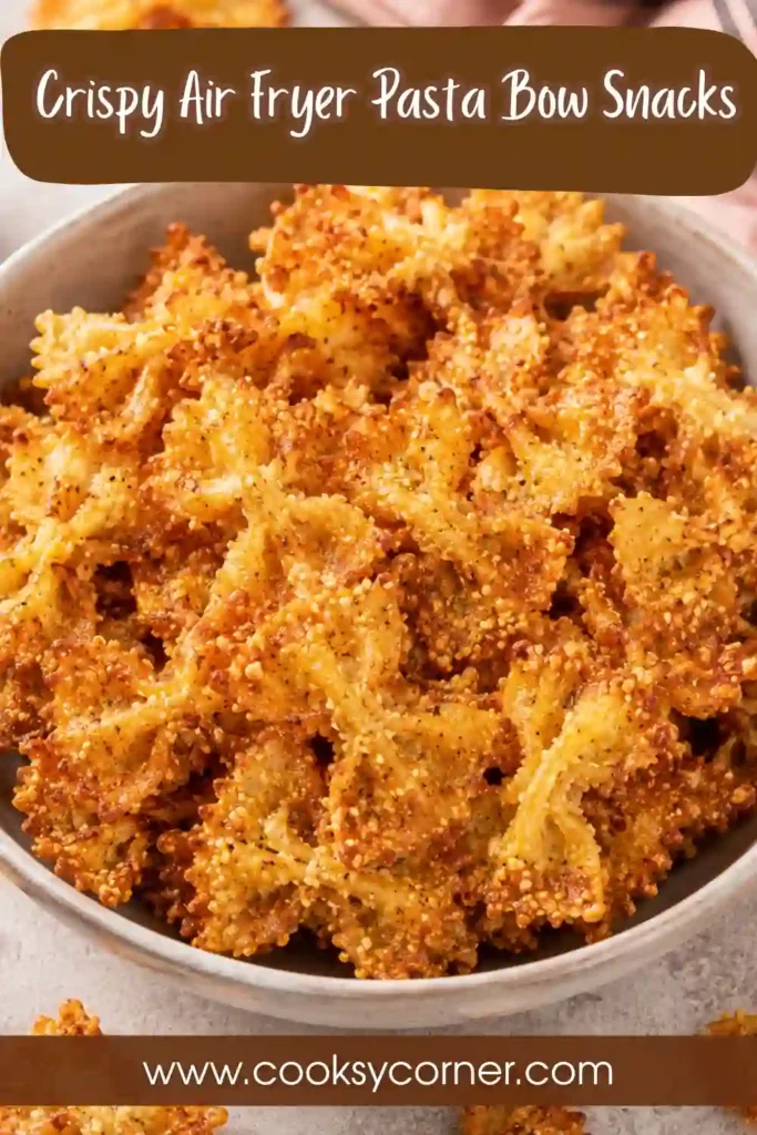 Homemade crispy pasta bow snacks with grated Parmesan and herbs, perfect for dipping into marinara sauce.
