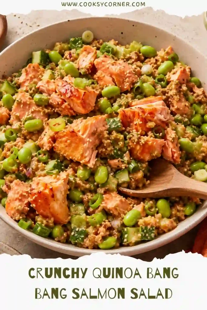 Crunchy Quinoa Bang Bang Salmon Salad served in a large bowl with crispy quinoa, shredded salmon, avocado, cucumbers, and creamy bang bang sauce.