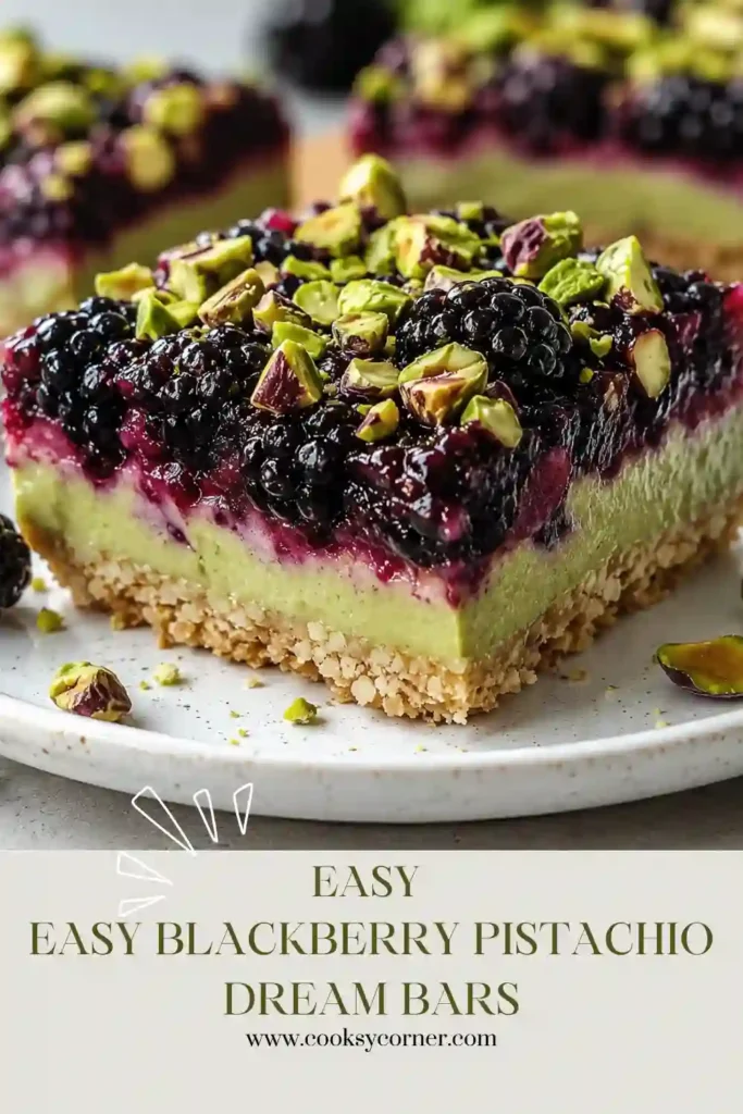 Blackberry Pistachio Dream Bars stacked on a dessert plate showing layers of buttery crust, blackberry filling, and pistachio crumble topping.