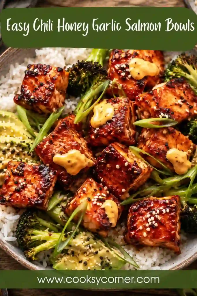 Healthy salmon bowl with roasted vegetables, avocado slices, sesame seeds, and chili honey garlic glazed salmon.