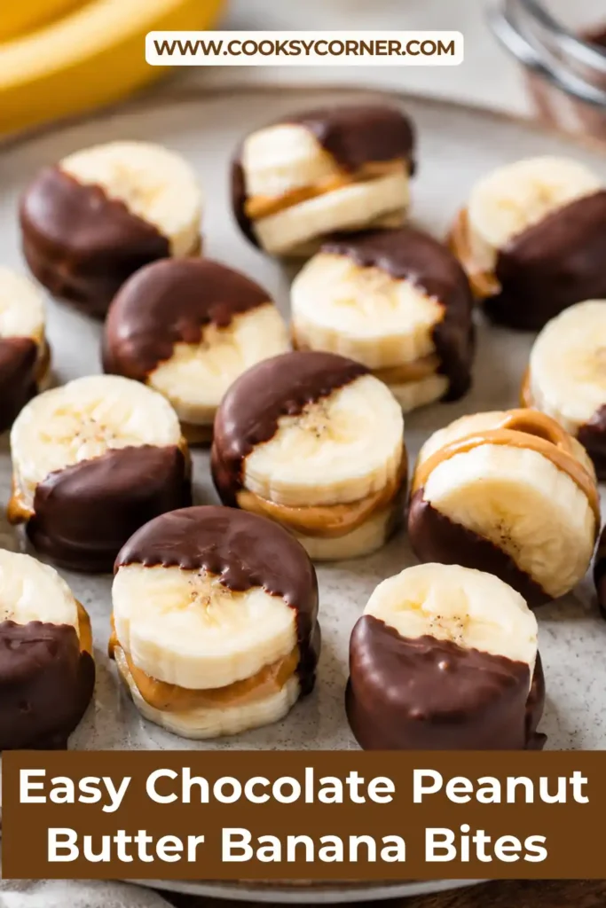 Chocolate Peanut Butter Banana Bites coated in dark chocolate and arranged on parchment paper. The frozen treats feature creamy peanut butter sandwiched between banana slices.
