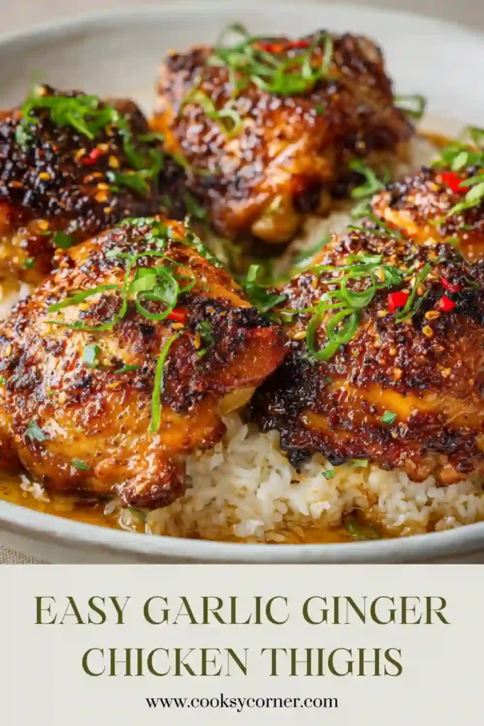 Crispy soy garlic chicken thighs arranged on a serving plate with fresh herbs and sesame seeds.