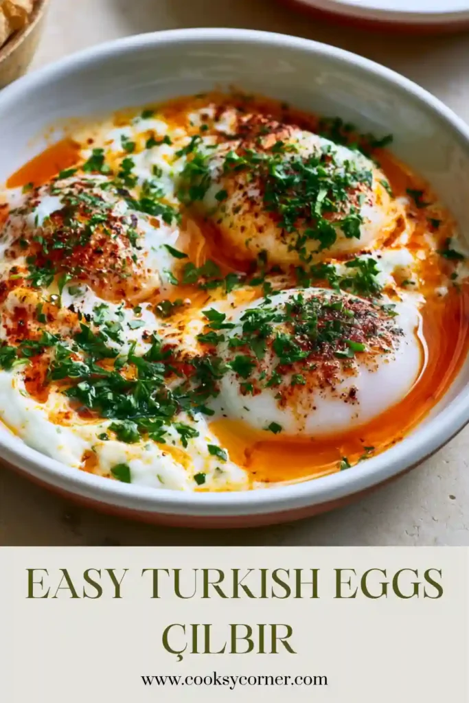 Poached eggs topped with paprika butter and served with crusty bread.