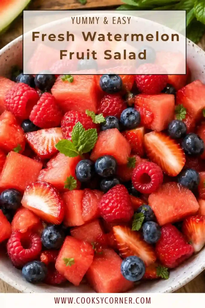 A colorful bowl of fresh watermelon fruit salad filled with juicy watermelon cubes, strawberries, blueberries, raspberries, and cherries. Fresh mint and lime dressing add a bright and refreshing summer flavor.