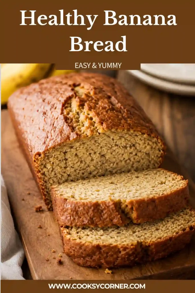 Healthy Banana Bread loaf sliced and served on a wooden board with fresh bananas nearby. A moist homemade quick bread made with ripe bananas and cinnamon.