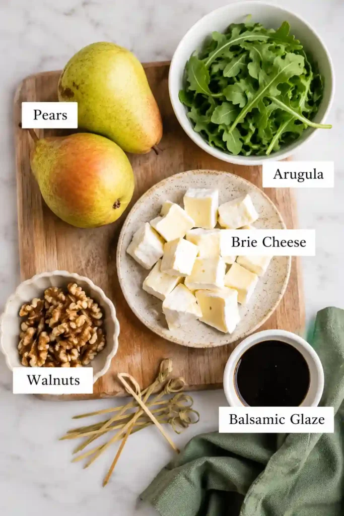 Homemade Pear & Brie Cheese Salad Skewers topped with balsamic glaze. These easy no-cook appetizer skewers offer a delicious sweet and savory flavor combination.
