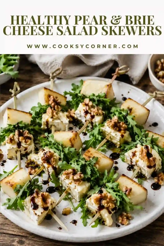 A platter of Pear & Brie Cheese Salad Skewers made with fresh pears, creamy brie cheese, arugula, walnuts, and balsamic glaze. This elegant appetizer is perfect for holiday entertaining and special gatherings.