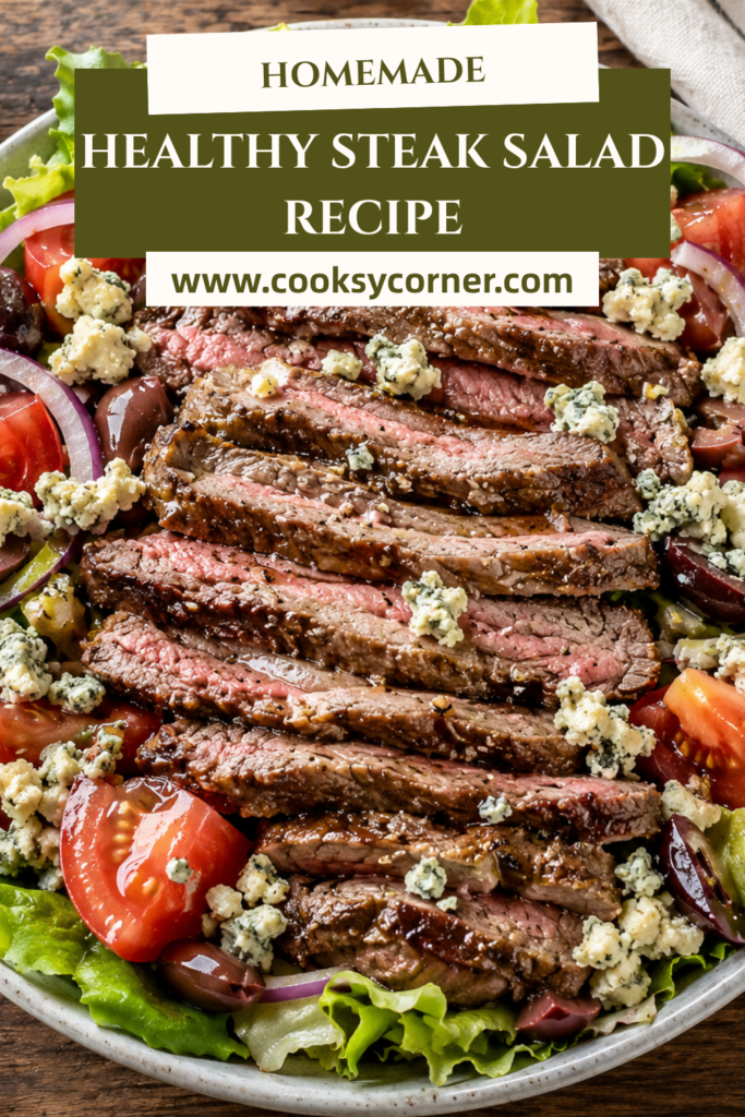 A fresh steak salad topped with sliced grilled steak, blue cheese crumbles, tomatoes, red onions, and Kalamata olives. The colorful ingredients are tossed with a homemade vinaigrette.