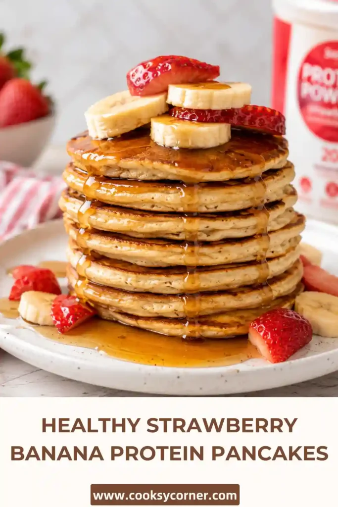 A plate of banana protein pancakes topped with strawberries and creamy yogurt drizzle. Fresh fruit adds color and natural sweetness.