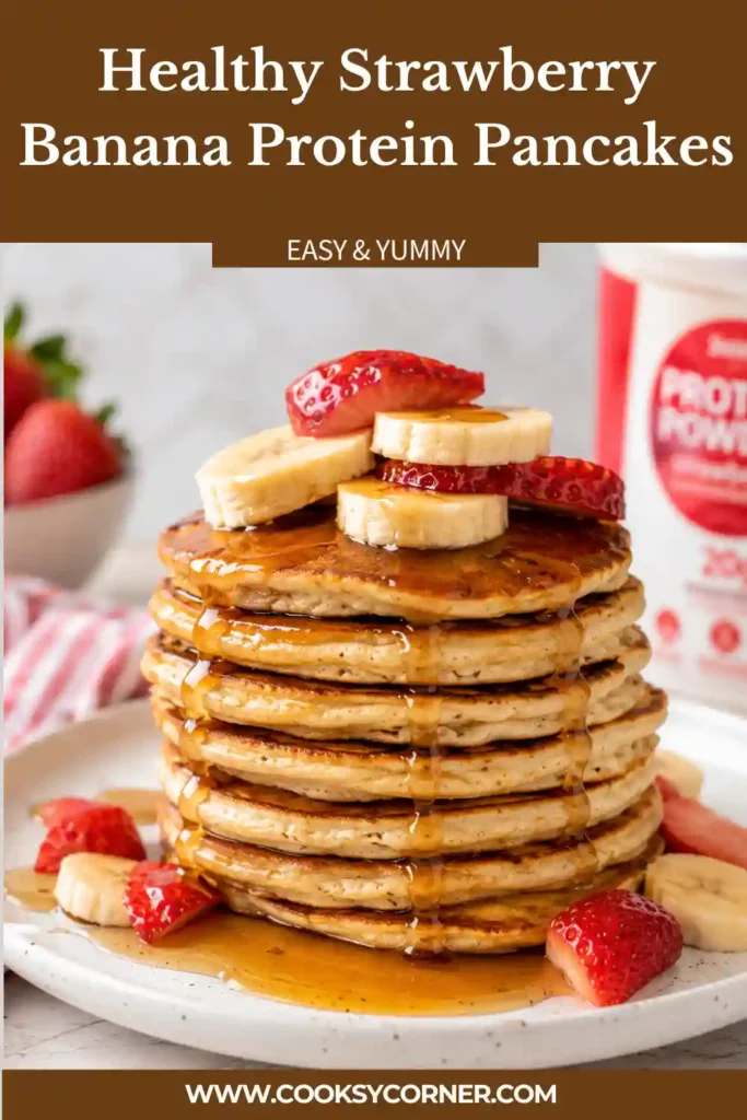 Stack of strawberry banana protein pancakes topped with vanilla yogurt and fresh chopped strawberries on a breakfast plate.