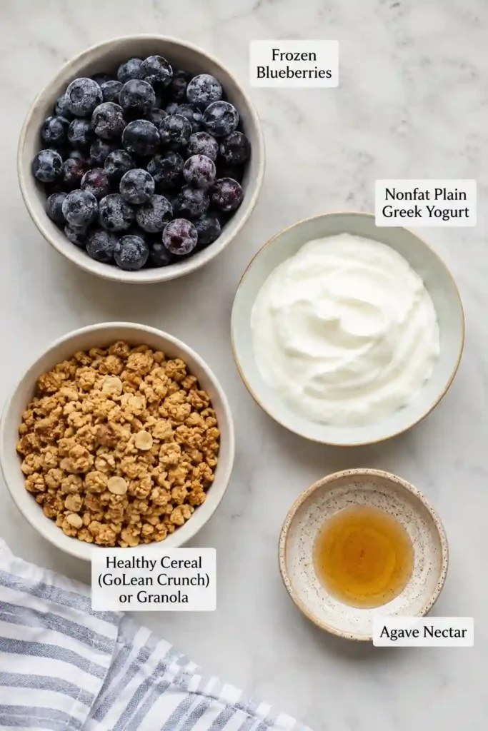 Healthy yogurt parfait featuring layers of blueberry compote, Greek yogurt, and granola. A quick and wholesome breakfast option for busy mornings.