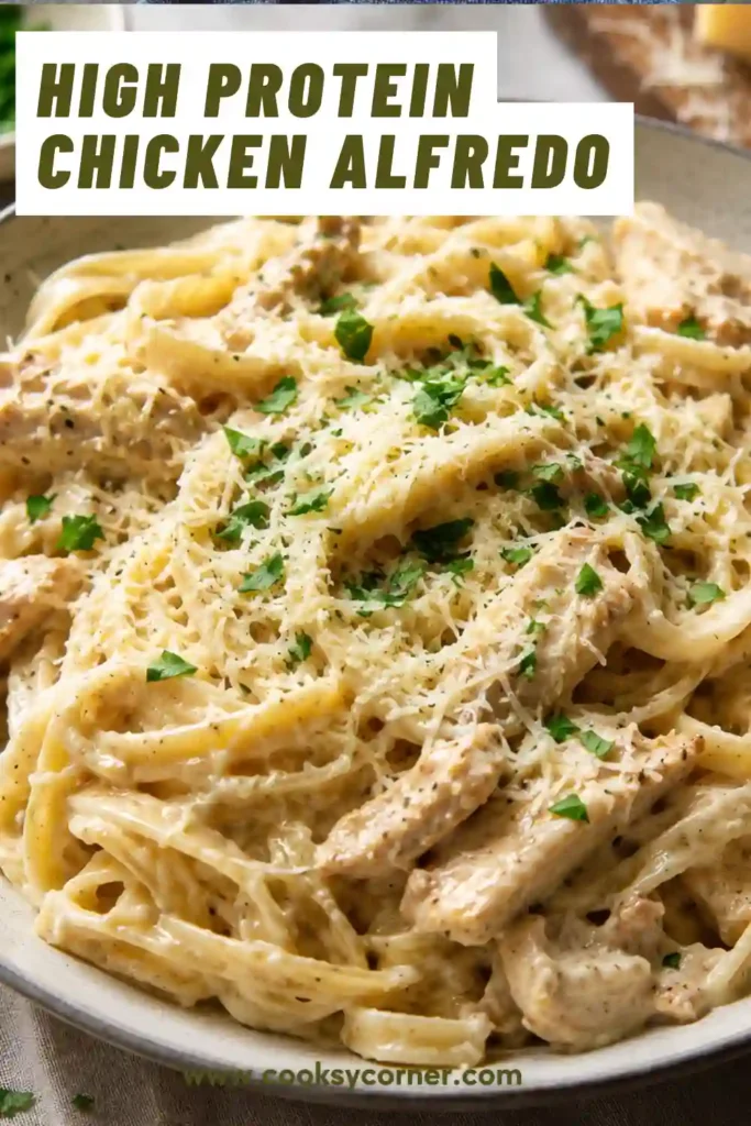 Close-up view of High Protein Chicken Alfredo featuring fettuccine coated in a smooth cottage cheese Alfredo sauce. Fresh parsley and parmesan add flavor and visual appeal.