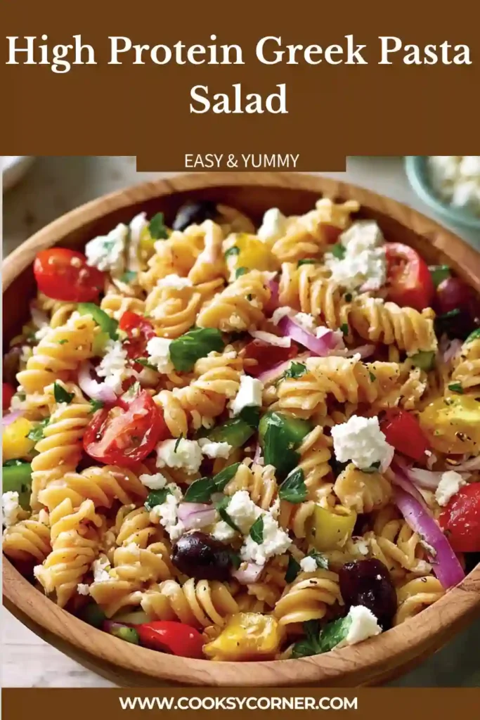 A bowl of High Protein Greek Pasta Salad filled with protein pasta, cucumbers, tomatoes, bell peppers, feta cheese, and fresh dill. The colorful Mediterranean ingredients create a healthy and vibrant meal.