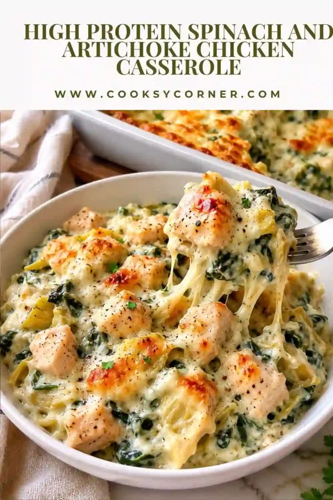 A baked High Protein Spinach and Artichoke Chicken Casserole topped with melted mozzarella and Parmesan cheese. The creamy chicken casserole is filled with spinach and artichokes and served fresh from the oven.