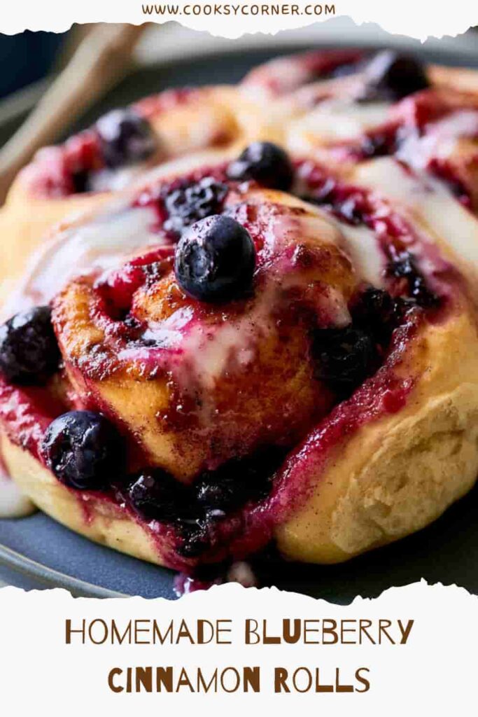 Freshly baked Blueberry Cinnamon Rolls topped with smooth cream cheese frosting and bursting with juicy blueberries. The soft golden rolls feature beautiful cinnamon swirls and bakery-style texture.