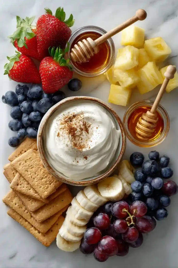 Greek yogurt dip drizzled with honey and sprinkled with cinnamon.