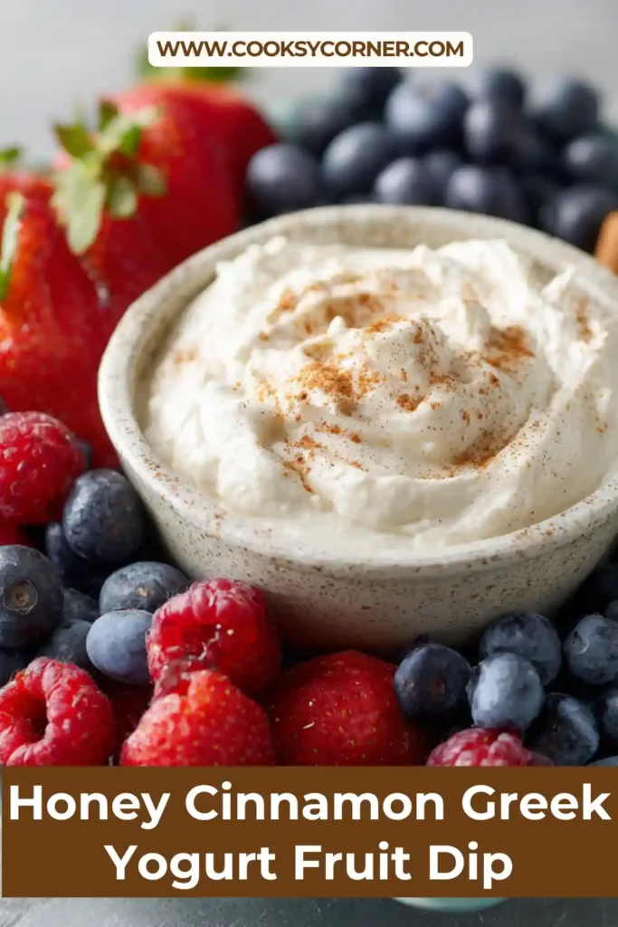Honey Cinnamon Greek Yogurt Fruit Dip served in a bowl surrounded by fresh berries, grapes, and pineapple.