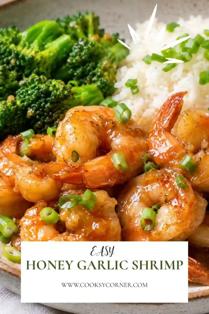 A skillet filled with honey garlic shrimp coated in a glossy sweet and savory sauce. Fresh green onions add color and flavor to this quick shrimp dinner recipe.