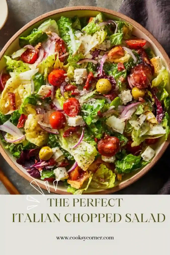 Fresh Italian Chopped Salad served in a large bowl with chopped vegetables, turkey salami, chickpeas, and grated Parmesan. A quick and flavorful salad recipe for any occasion.