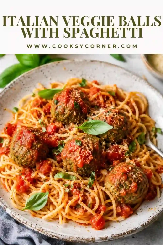Healthy Italian Veggie Balls made from lentils, spinach, and pesto served with spaghetti. A comforting vegetarian pasta dinner topped with fresh basil leaves.
