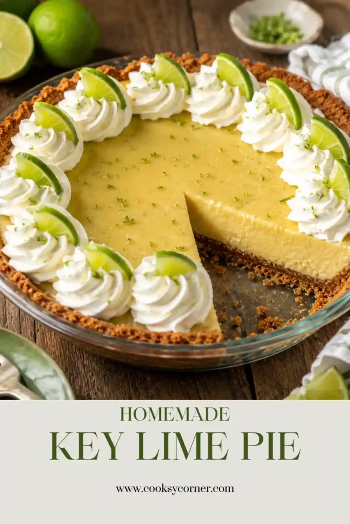 A slice of Key Lime Pie Recipe topped with whipped cream and fresh lime zest on a white dessert plate. The creamy citrus filling sits inside a golden graham cracker macadamia nut crust.