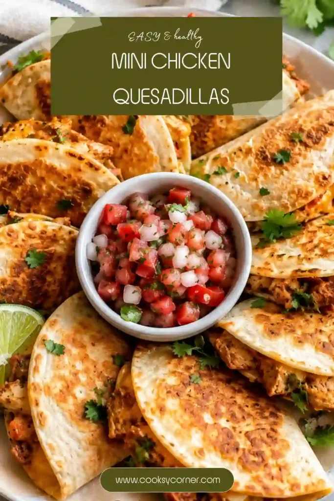 Mini Chicken Quesadillas served on a platter with guacamole, pico de gallo, and sour cream. These crispy bite-sized chicken quesadillas are filled with melted cheese and shredded rotisserie chicken.