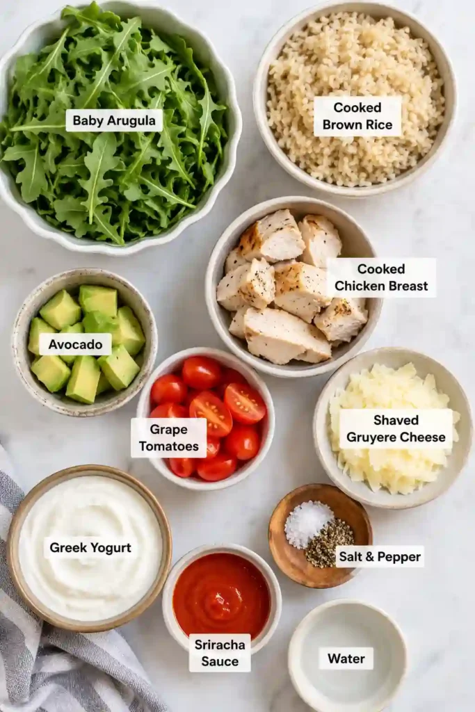 Nutritious Chicken Brown Rice Bowl featuring grilled chicken, brown rice, avocado, tomatoes, Gruyère cheese, and homemade yogurt dressing.