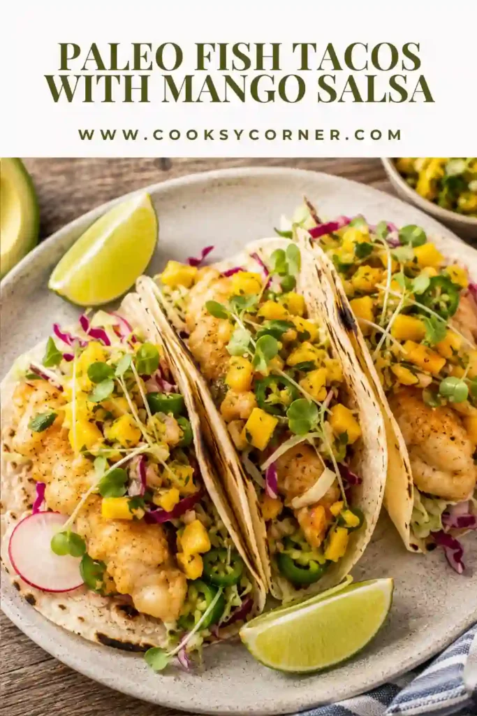 Crispy paleo fish tacos filled with golden fish, mango salsa, avocado, cabbage, and fresh cilantro served on grain-free tortillas.