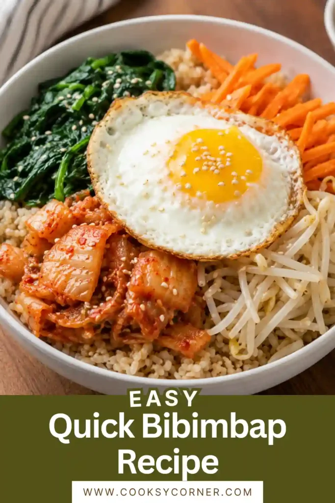 A colorful Quick Bibimbap Recipe served in a bowl with jasmine rice, sautéed spinach, bean sprouts, carrots, kimchi, a fried egg, Sriracha, and toasted sesame seeds. This Korean-inspired rice bowl is fresh, vibrant, and perfect for an easy dinner.