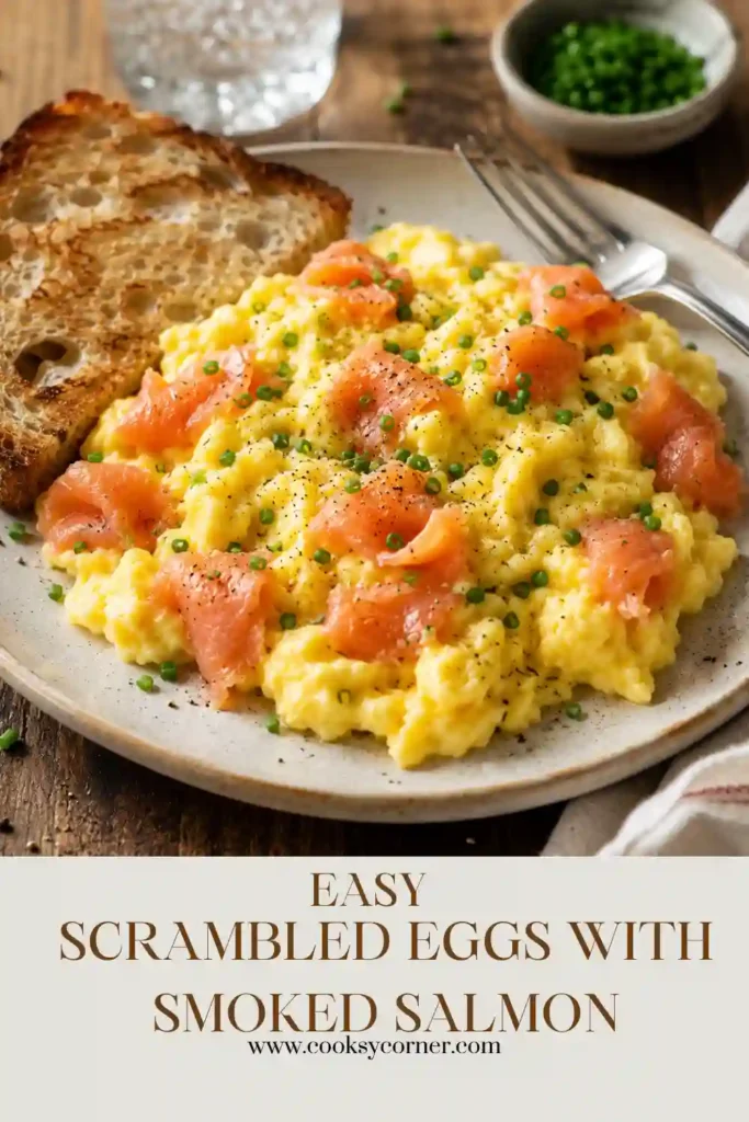 Freshly cooked scrambled eggs mixed with smoked salmon and garnished with chopped chives. A simple gourmet breakfast ready in minutes.