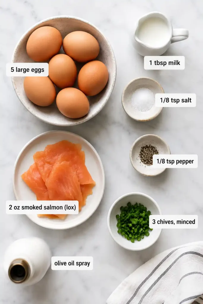 A plate of creamy scrambled eggs topped with smoked salmon and fresh chives. This high-protein breakfast recipe looks elegant and perfect for a healthy morning meal.