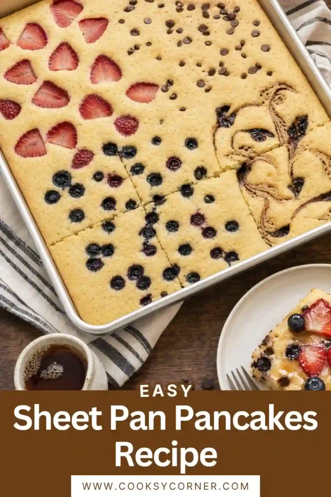 Freshly baked Sheet Pan Pancakes sliced into squares and topped with blueberries, strawberries, chocolate chips, and cinnamon swirl. This easy oven baked breakfast is perfect for feeding a family.